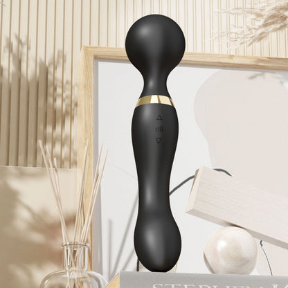 Black handheld device with gold accent on a neutral background